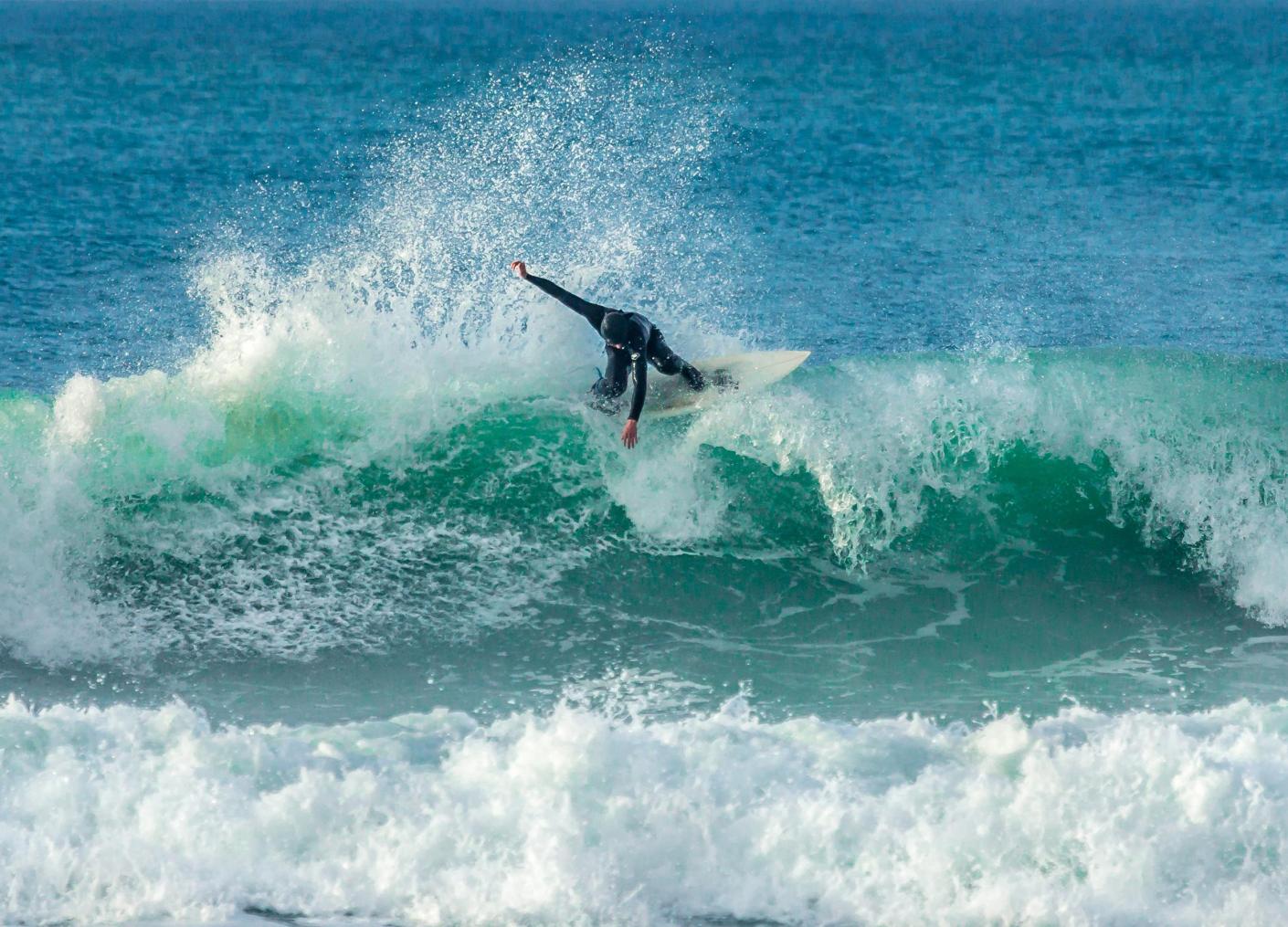 Surfer catching wave in UK