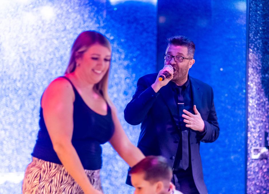 Guests dancing to live entertainment inside the Woolacombe Sands Holiday Park Clubhouse