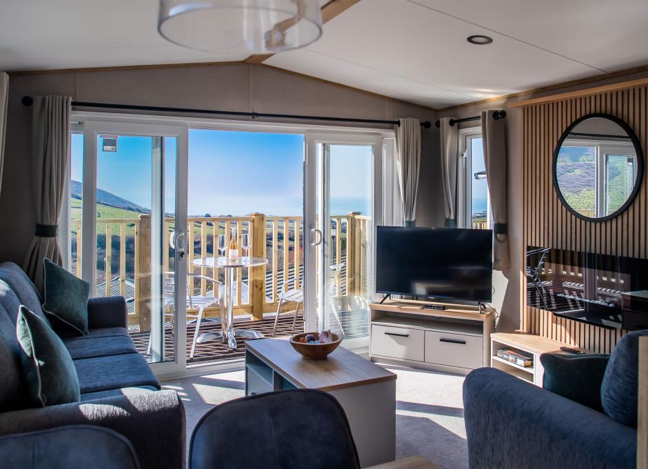 An interior view of a Diamond Caravan at Woolacombe Sands Holiday Park showing the living area